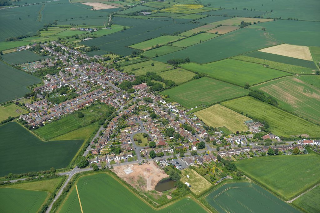 an aerial view of the village of warton and surrounding warwickshire countryside